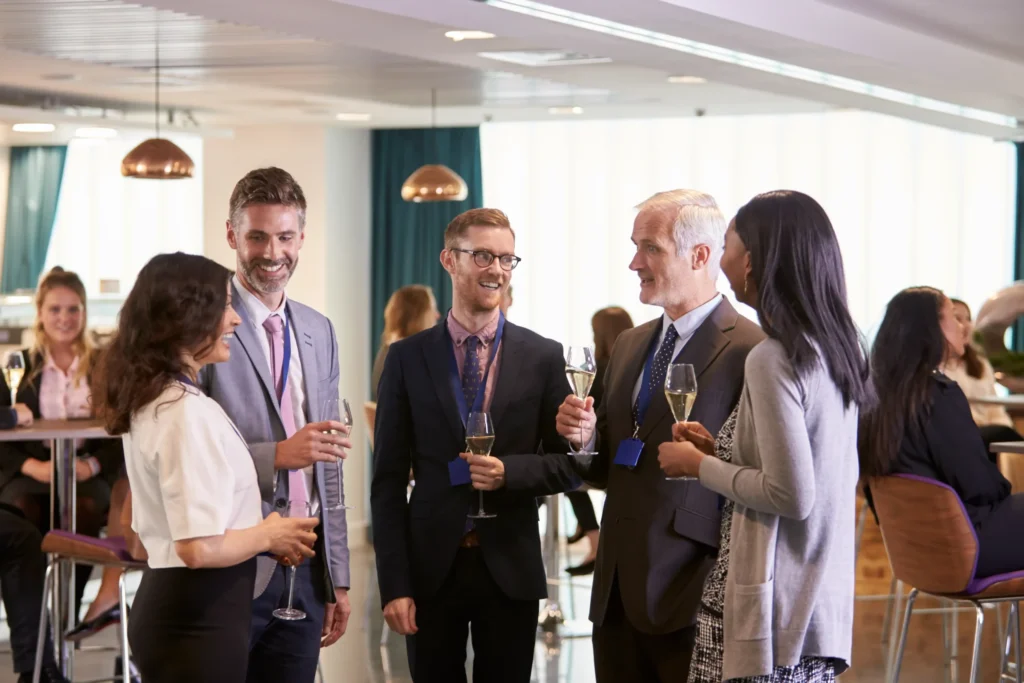 Business professionals networking and toasting champagne at corporate reception.