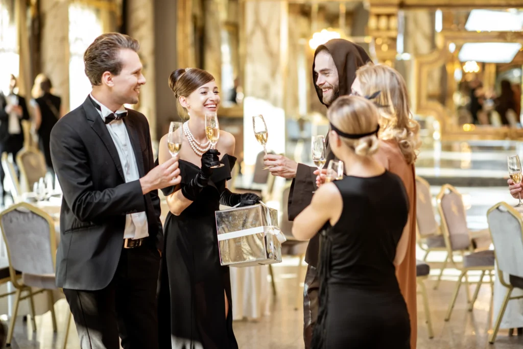Well-dressed guests toasting champagne and exchanging gift at formal gala.