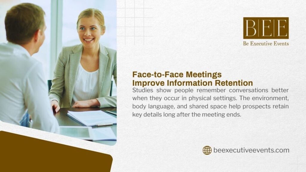 Professional woman in blazer smiling during face-to-face business meeting with male colleague across table, emphasizing body language, shared space, and information retention in physical setting
